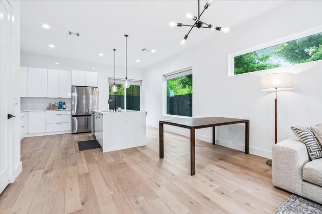a view of kitchen with furniture and a wooden floor