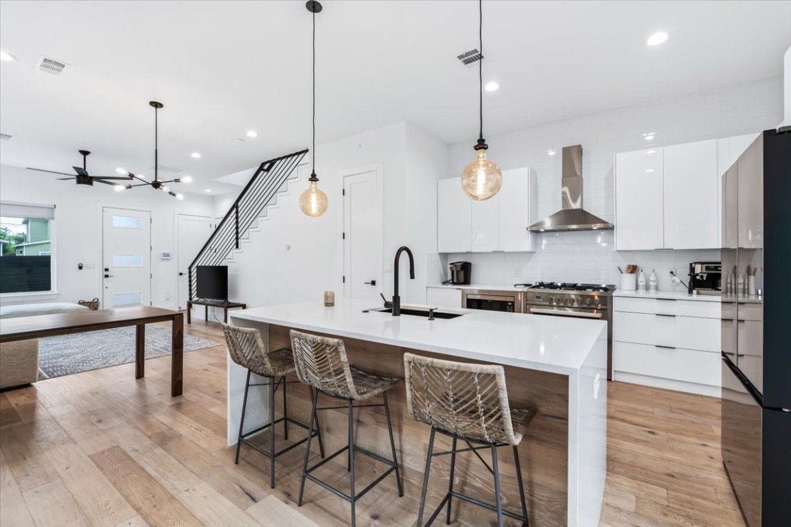 6300 Santos Street, Unit 3 Austin, TX 78741 - Photo 10 of 32 a kitchen with stainless steel appliances granite countertop a sink a stove and a wooden floors