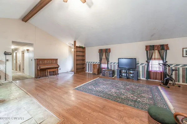 a view of a livingroom with furniture and a flat screen tv