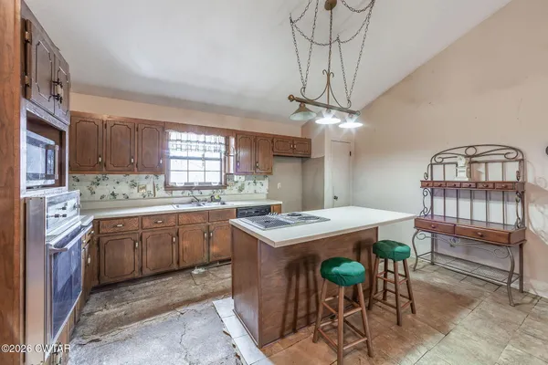 a kitchen that has a table and chairs in it