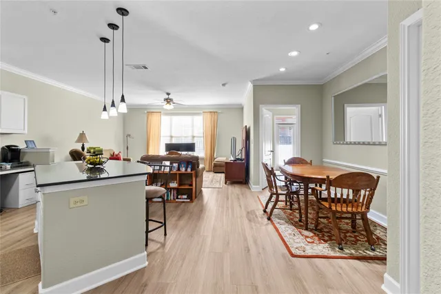 a view of a dining room with furniture and chandelier