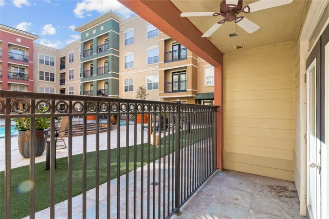 a view of a balcony with a ceiling fan
