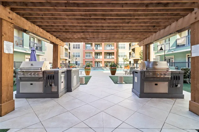 a large kitchen with stainless steel appliances granite countertop a stove and cabinets