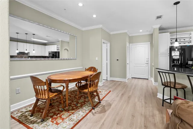 a dining room with furniture and wooden floor