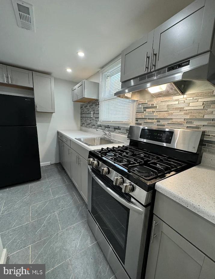 2630 McCarey Street Chester, PA 19013 - Photo 3 of 11 a stove top oven sitting inside of a kitchen