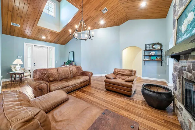 a dining room with furniture and wooden floor