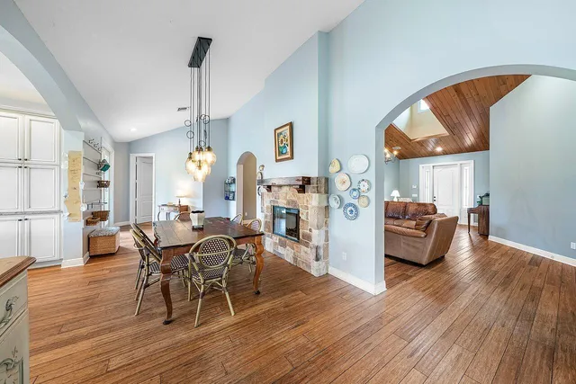 a kitchen with kitchen island granite countertop a large counter top space stainless steel appliances and windows