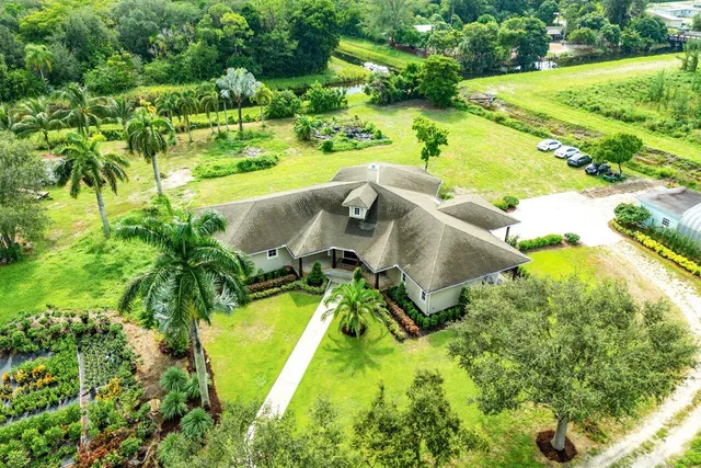 an aerial view of a swimming pool with yard