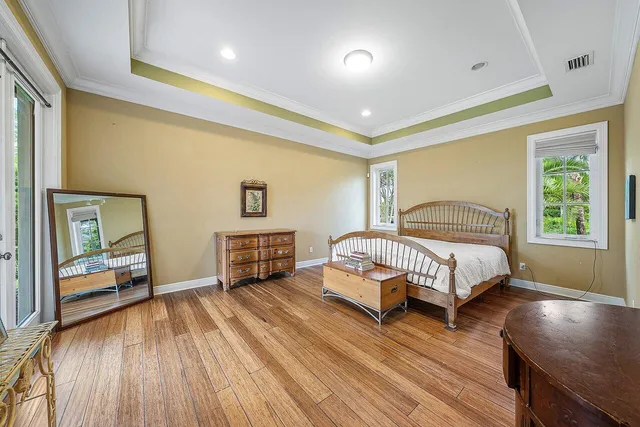 a view of a kitchen with refrigerator and wooden floor