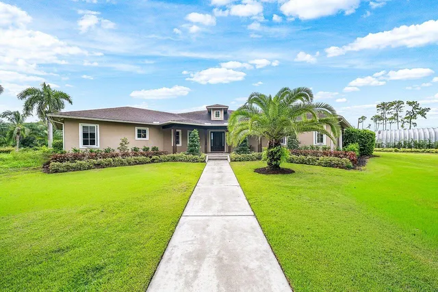 a living room with furniture a fireplace and a chandelier