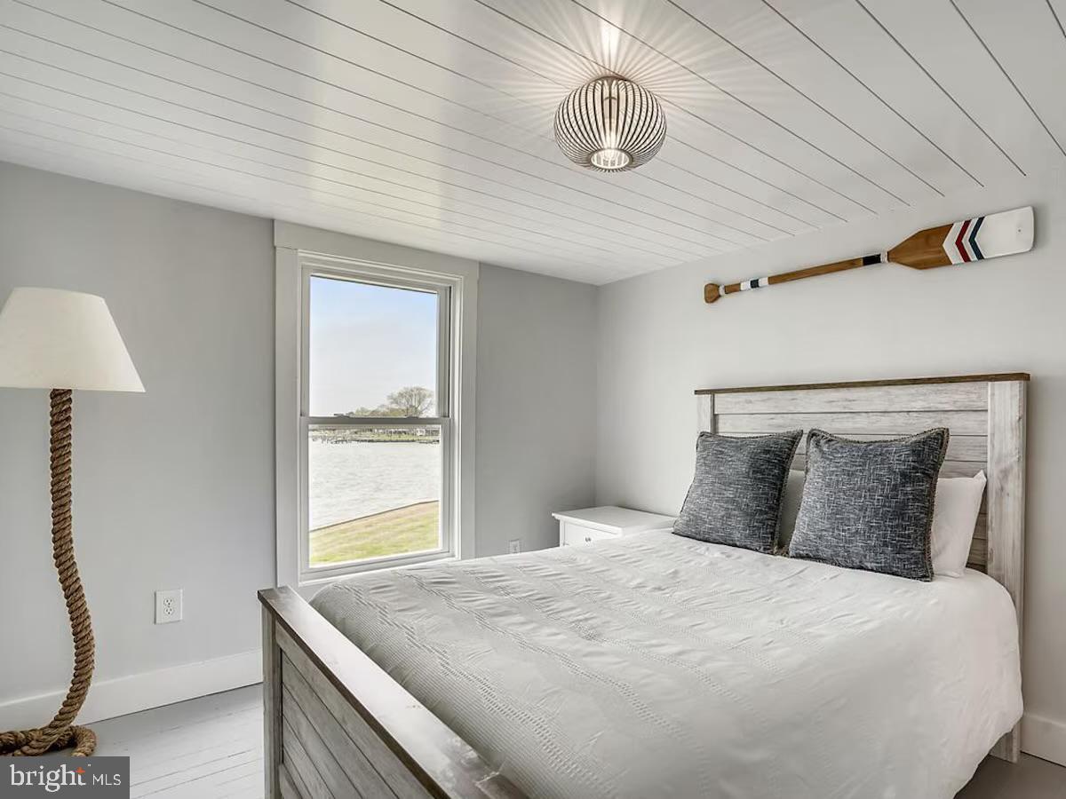 21642 Chicken Point Road Tilghman, MD 21671 - Photo 40 of 63 a bedroom with a bed and a window