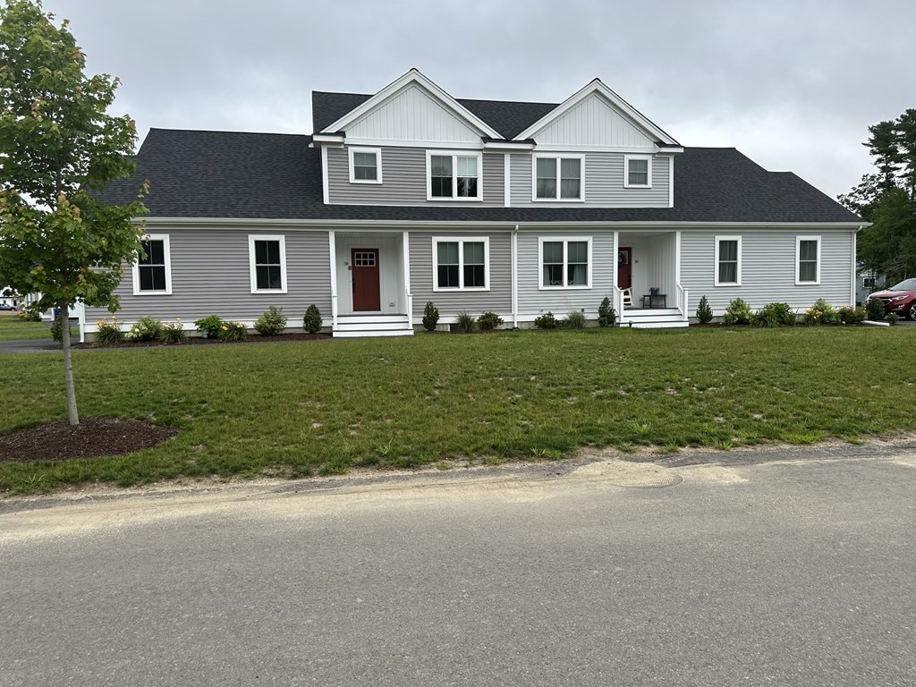 7 Hayley Circle, Unit 34 Rochester, MA 02770 - Photo 1 of 12 a front view of a house with a garden