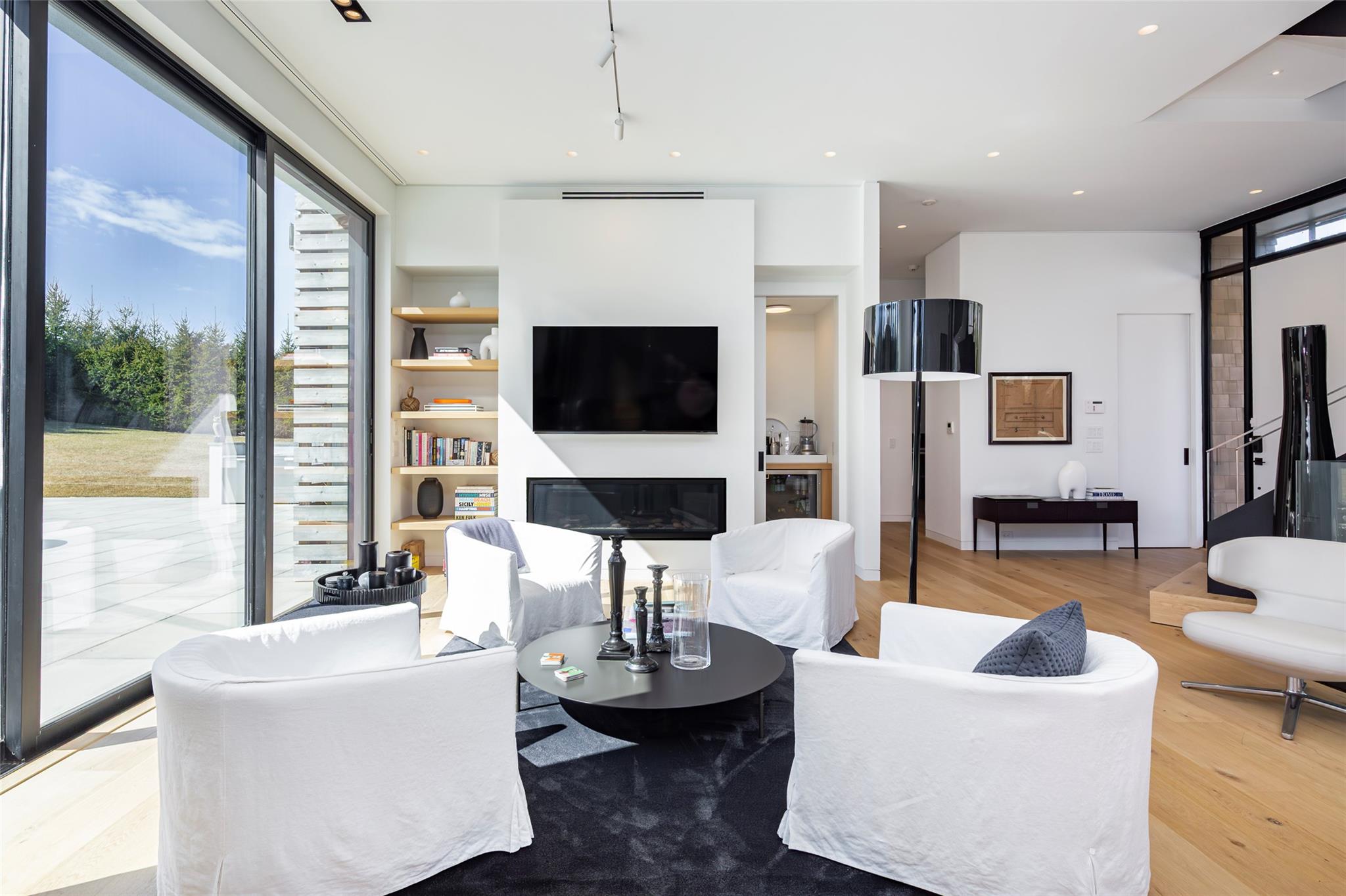 179 Montauk Highway East Hampton, NY 11937 - Photo 12 of 47 a living room with furniture a fireplace and a flat screen tv