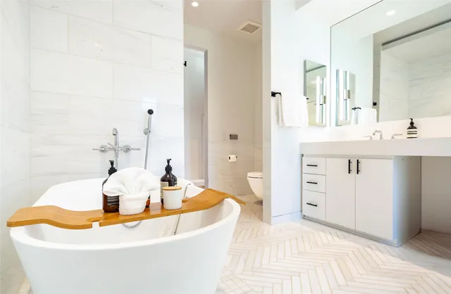 a bath tub sitting next to a bathroom sink