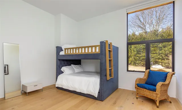 a bed sitting in a bedroom next to a window