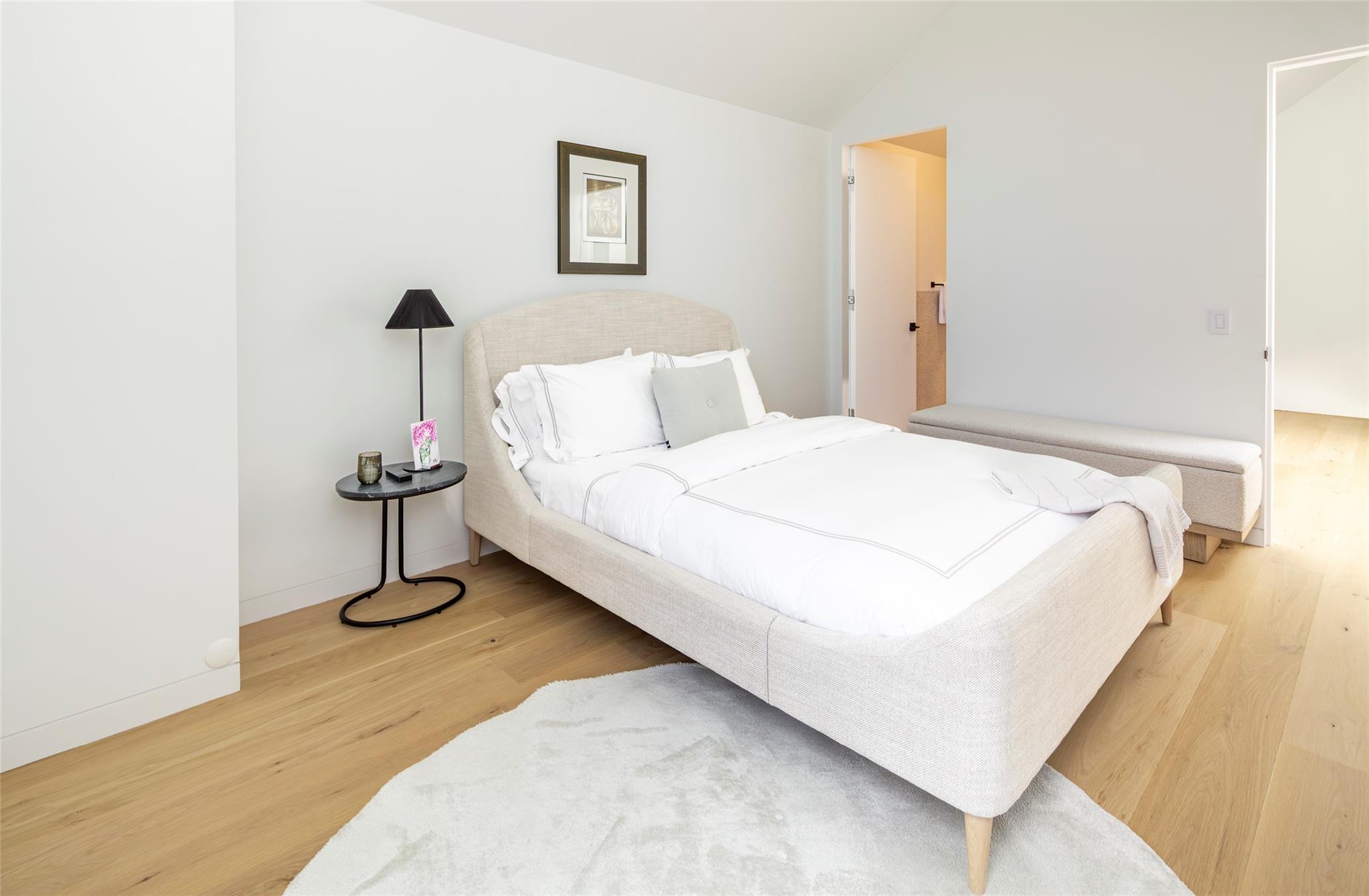 179 Montauk Highway East Hampton, NY 11937 - Photo 30 of 47 a bedroom with a bed and a table