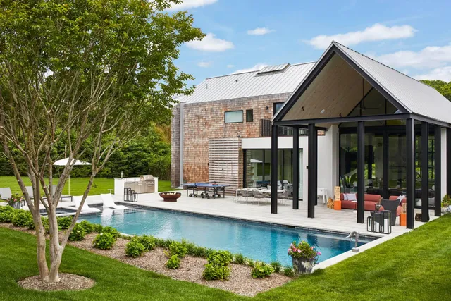 a view of a house with swimming pool and sitting area