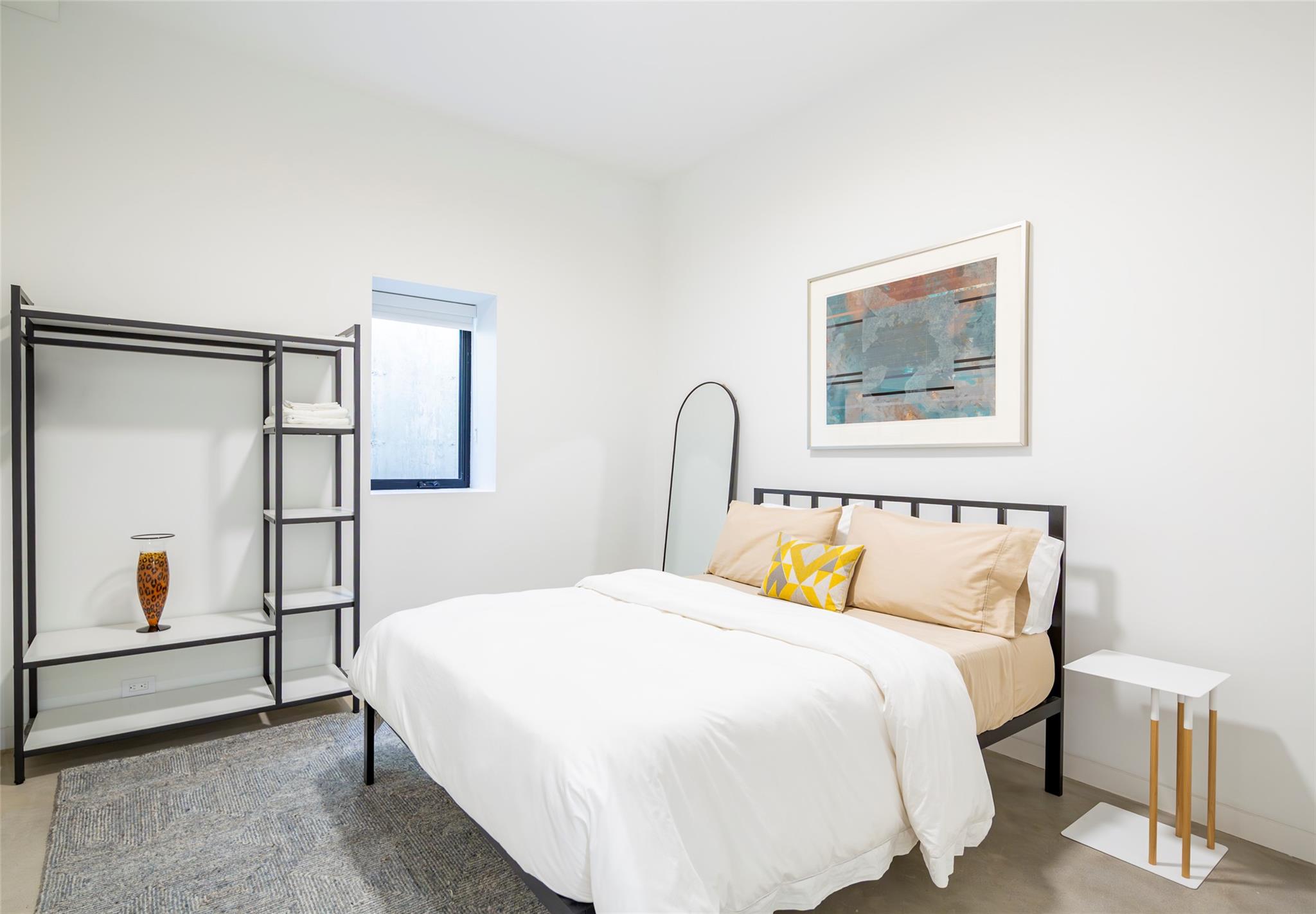 179 Montauk Highway East Hampton, NY 11937 - Photo 39 of 47 a bedroom with a bed and a painting