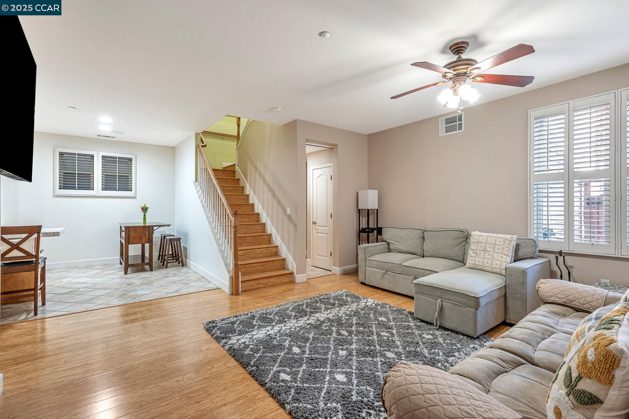 2036 Serra Lane Hercules, CA 94547 - Photo 12 of 60 a living room with furniture and a dining table with wooden floor