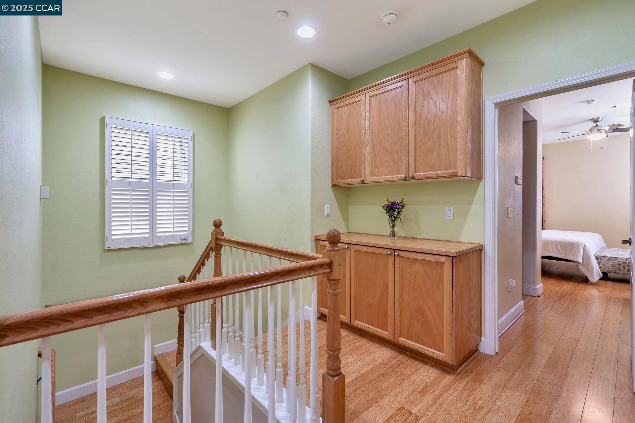 2036 Serra Lane Hercules, CA 94547 - Photo 22 of 60 a kitchen with sink cabinets and wooden floor