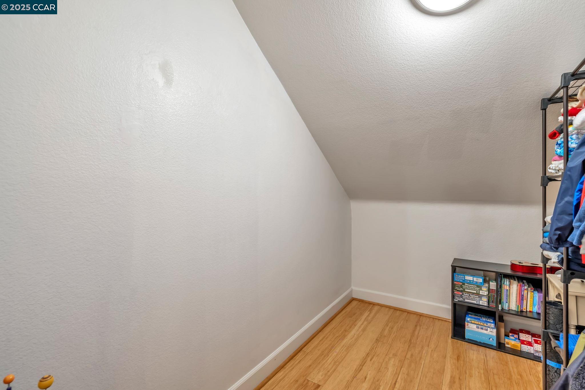 2036 Serra Lane Hercules, CA 94547 - Photo 29 of 60 a view of a hallway with wooden floor and a shelf