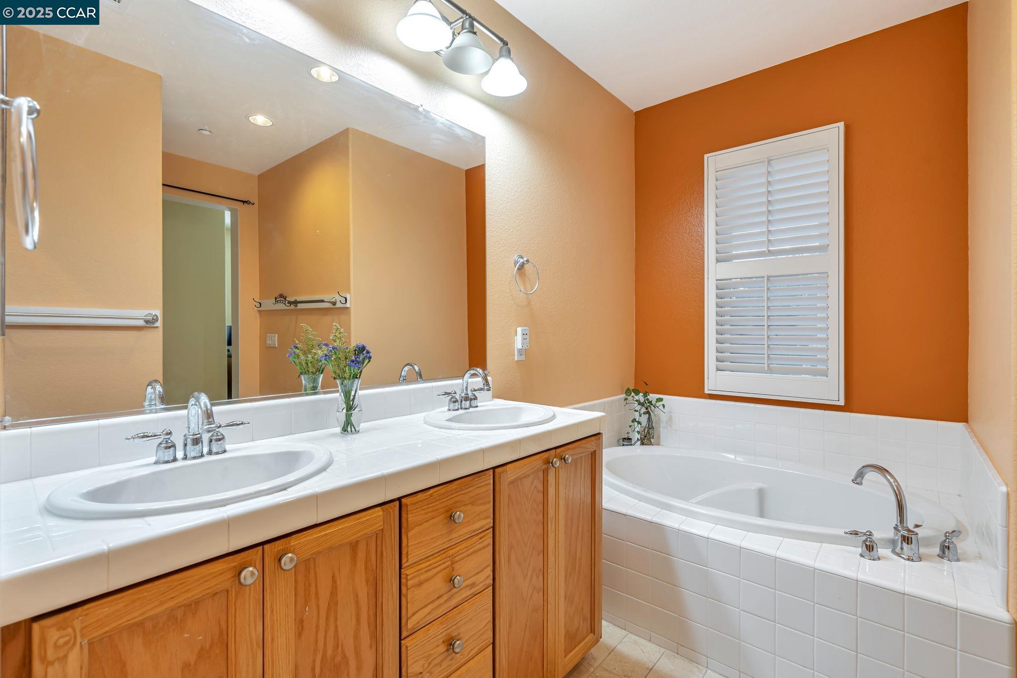 2036 Serra Lane Hercules, CA 94547 - Photo 34 of 60 a bathroom with a granite countertop sink mirror and a bathtub