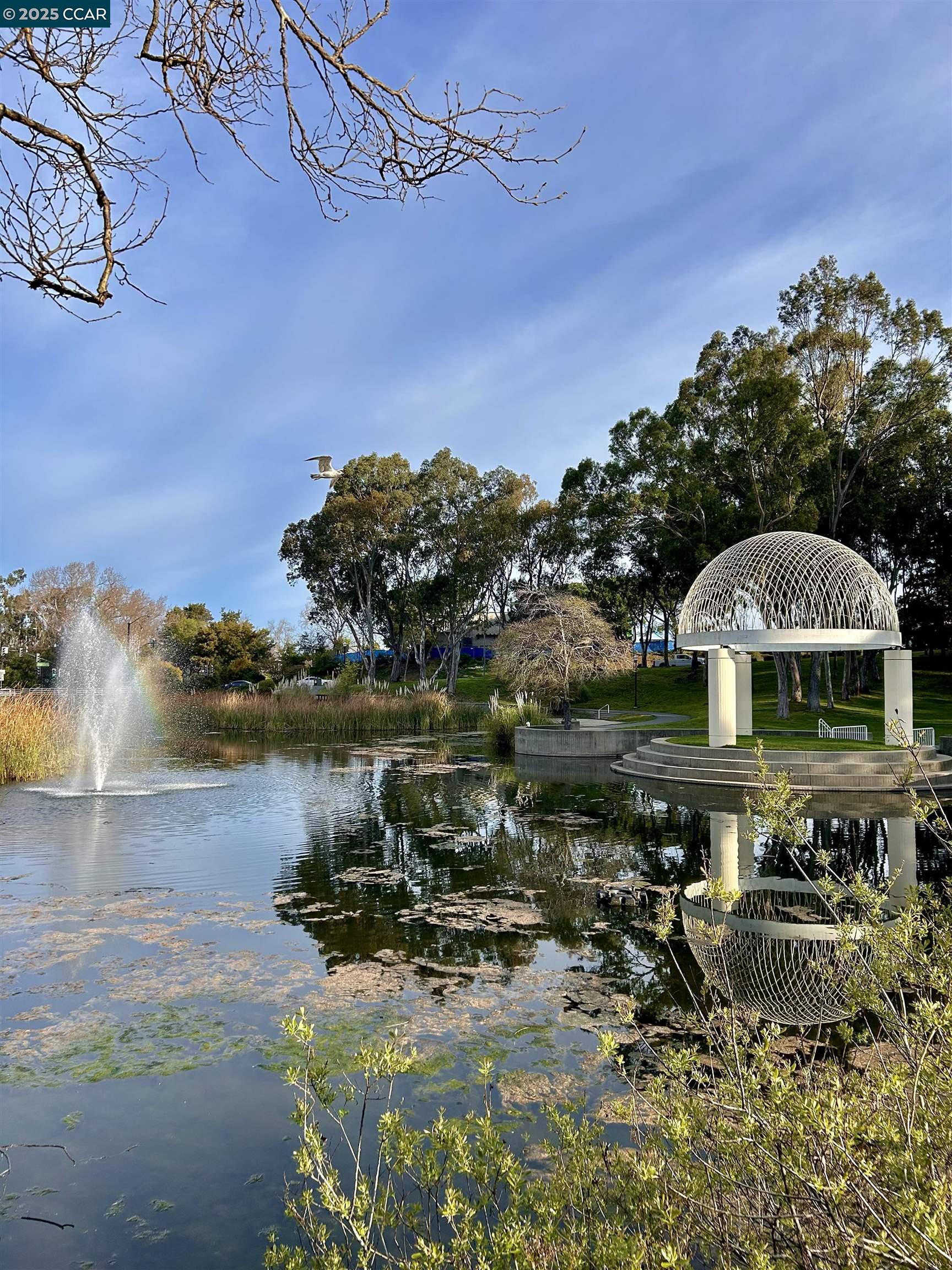 2036 Serra Lane Hercules, CA 94547 - Photo 53 of 60 a view of a lake with lawn chairs under an umbrella