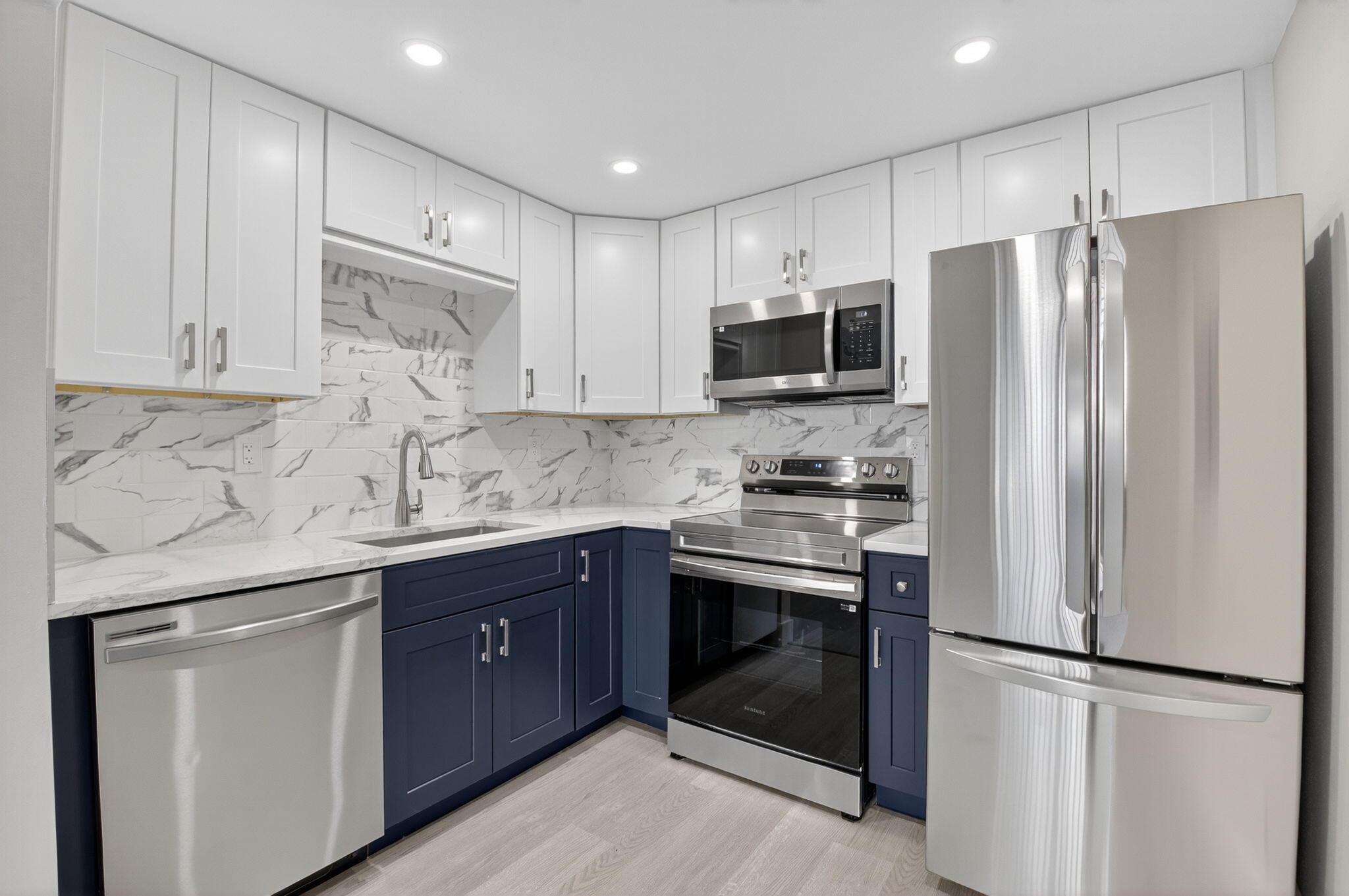 a kitchen with stainless steel appliances a refrigerator sink and microwave