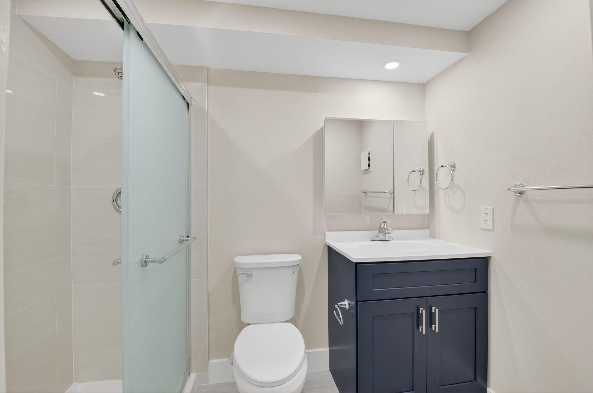 538 Normandy Lane Delray Beach, FL 33484 - Photo 14 of 66 a bathroom with a sink a toilet a mirror and vanity