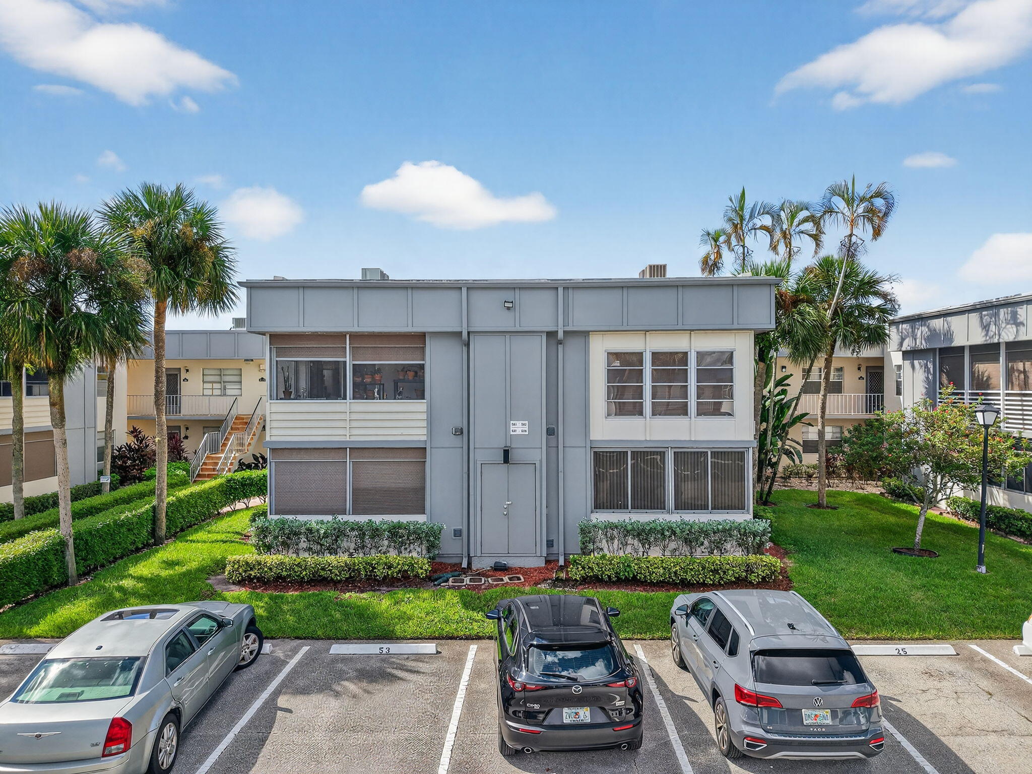 538 Normandy Lane Delray Beach, FL 33484 - Photo 26 of 66 a front view of a house with a garden and plants