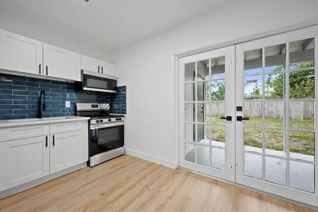 a kitchen with stainless steel appliances a stove top oven and a refrigerator