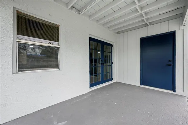 a view of an empty room with a fireplace and a window