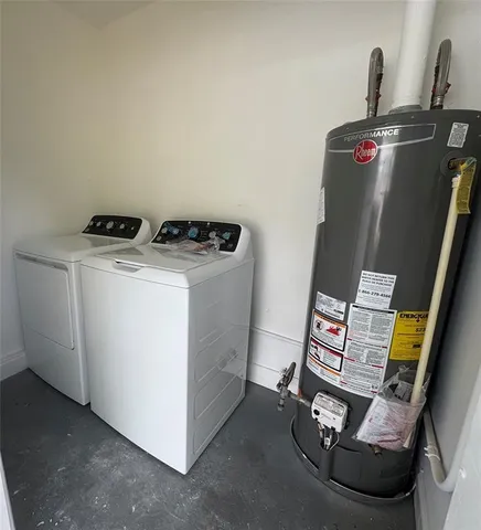 a utility room with dryer washer and sink