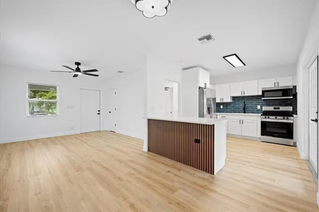 a kitchen with stainless steel appliances granite countertop a stove a sink and a refrigerator