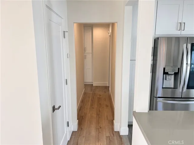 a view of a kitchen from a hallway