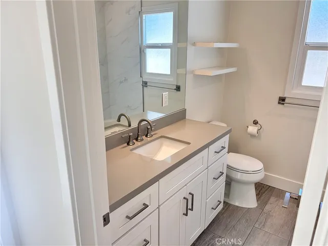 a bathroom with a sink toilet and vanity
