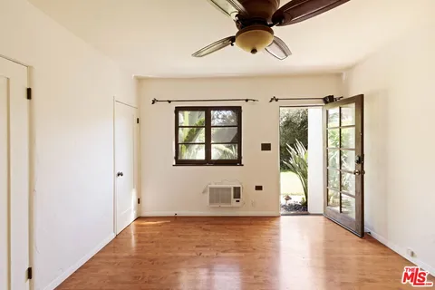 a view of a livingroom with a ceiling fan and window