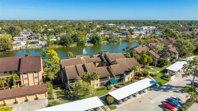 an aerial view of a house with outdoor space and lake view
