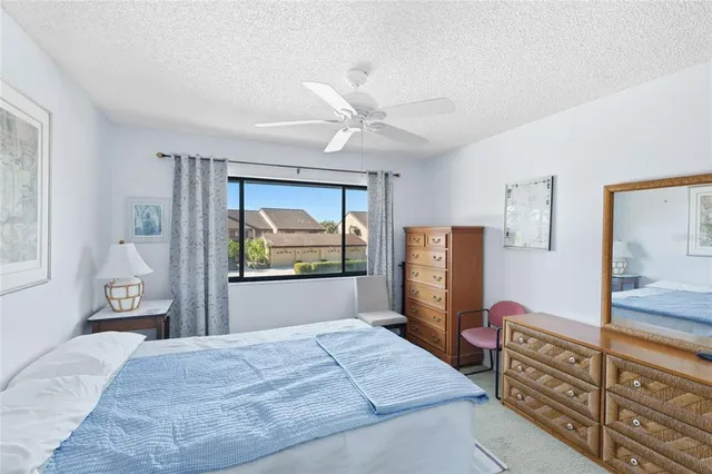 a bedroom with a bed and a dresser with mirror