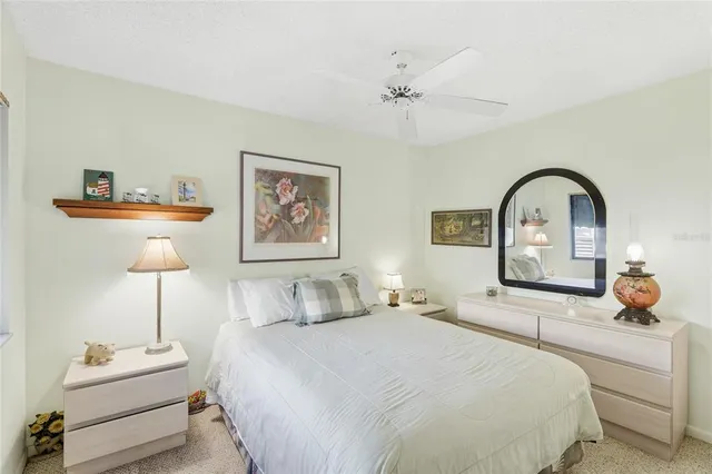 a bedroom with a bed and a painting on the wall