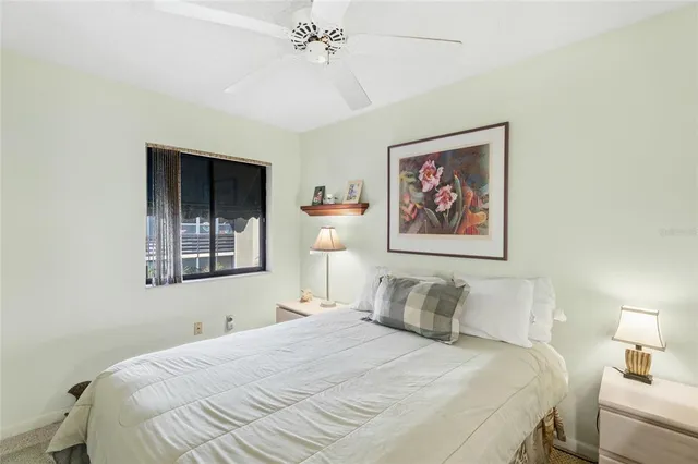 a bedroom with a bed and a lamp on table