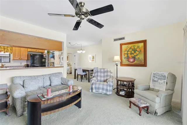 a living room with furniture and a ceiling fan