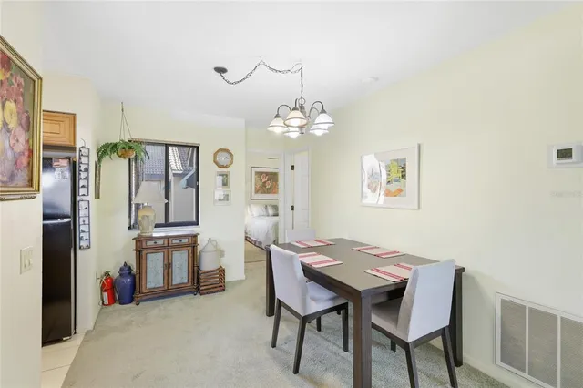 a view of a dining room with furniture and chandelier