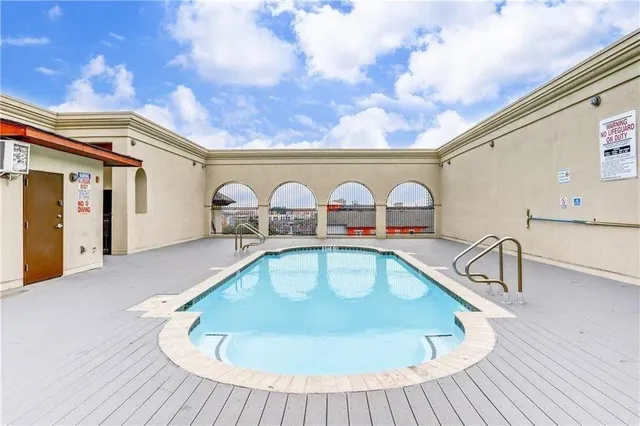 a view of a swimming pool with a lounge chair