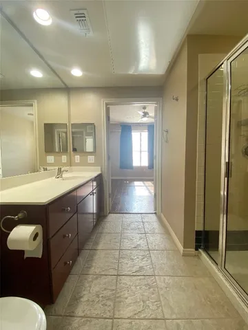 a bathroom with a sink a toilet and mirror