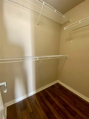 a view of a room with wooden floor