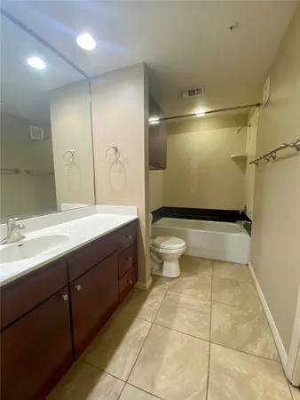 a bathroom with a double vanity sink toilet and shower