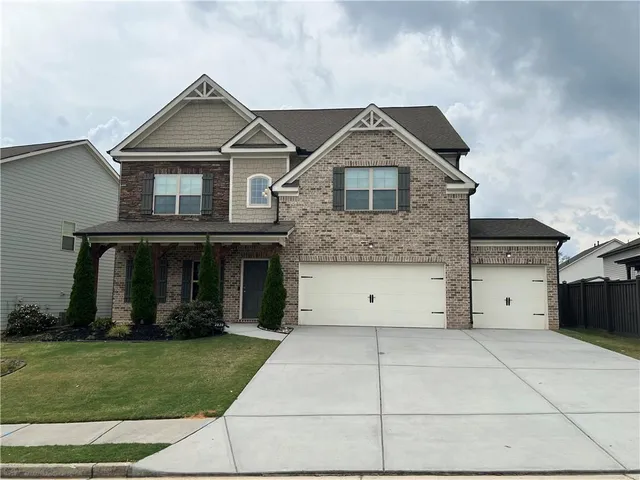 a front view of a house with a garden