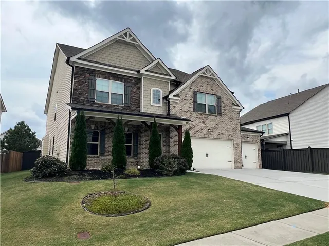 a front view of a house with a yard