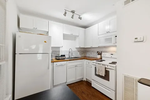 a kitchen with stainless steel appliances granite countertop a refrigerator sink and cabinets